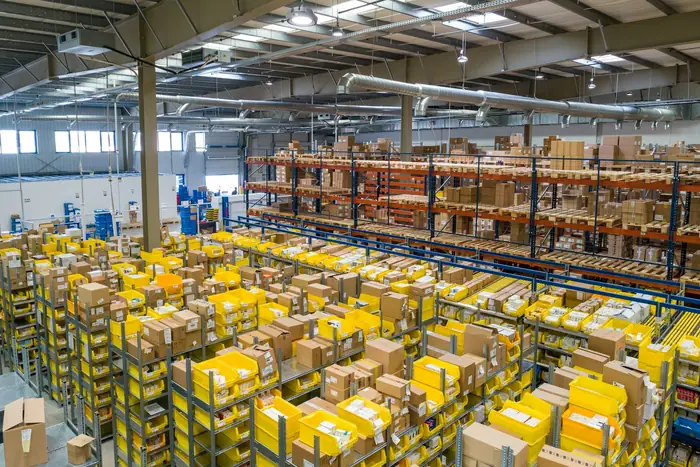 Prep center floor with rows of racking and cartons